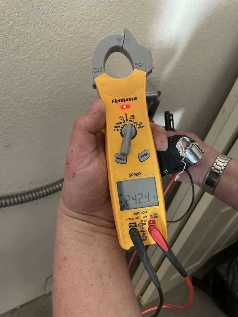 Voltage testing with clamp meter during Outlet Installation in Wake Forest